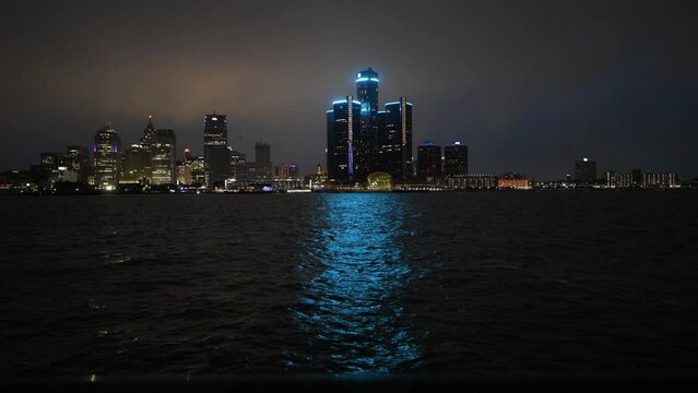 Skyline of Downtown Detroit, Michigan at night on a rainy day taken from across the Detroit river in Windsor, Ontario 