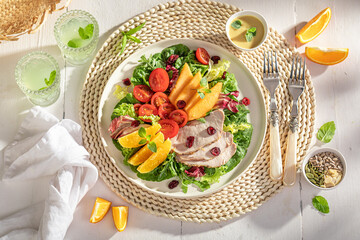 Healthy salad served with lemonade in summer.