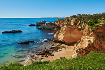 Solitary beach close to Alvor village in Portugal. There are lots of limestone rocks in the water...