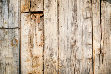 Dark stained reclaimed wood surface with aged boards lined up. Wooden floor planks with grain and texture.