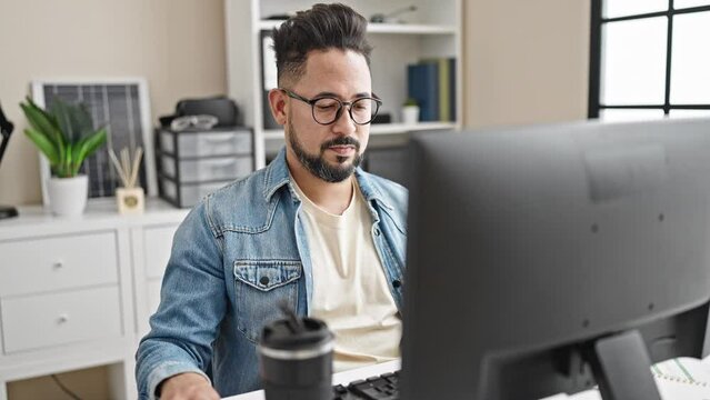 Young latin man business worker working tired stretching back at office