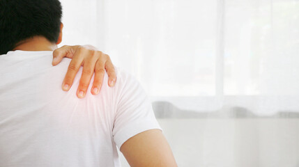 Man having shoulder pain because of muscle inflammation , under the concept of health care