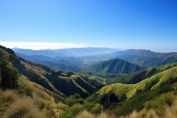 Naklejka premium mountain range, with view of rolling hills and green valleys below, against blue sky, created with generative ai