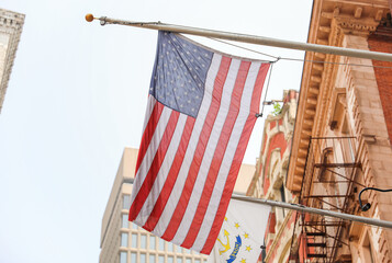 US flag waves proudly in front of an American home, representing the meaning and symbolism of...