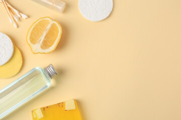 Lemon face cleanser. Fresh citrus fruits and personal care products on beige background, flat lay with space for text