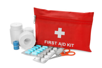 Red first aid kit, scissors, pins, pills, medical plaster and elastic bandage isolated on white