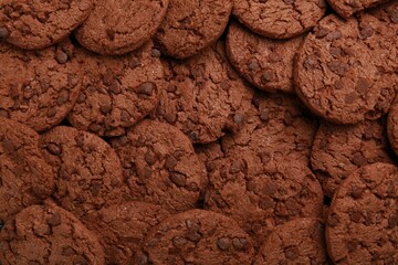 Tasty chocolate cookies as background, top view