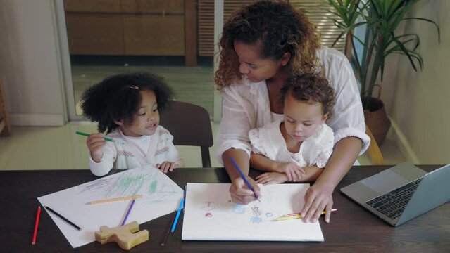 African mother multitasking painting with child while work from home