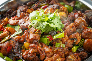 Special Sichuan cuisine griddle chicken on dark background