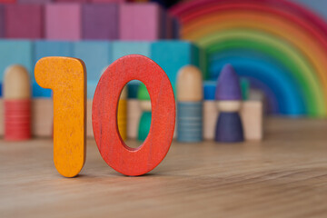 Wooden 10 on rainbow background
