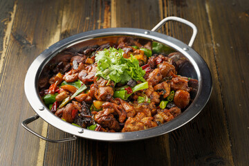 Special Sichuan cuisine griddle chicken on dark background