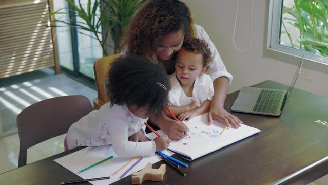 African mother multitasking painting with child while work from home