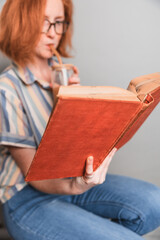 woman reading a book drinking coffee