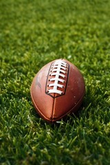 close-up of an american football on a grass field, created with generative ai