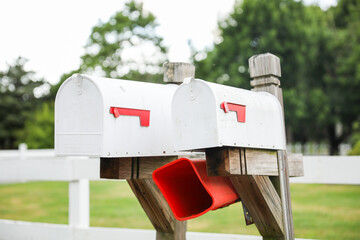 mailbox stands tall against a backdrop of greenery, symbolizing communication, connection, and the...