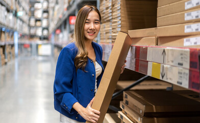 Portrait asian businesswoman shipping order detail check goods and supplies on shelves with goods background inventory in factory warehouse.logistic industry and business import export