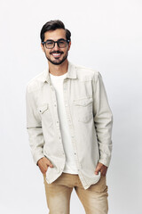 Man fashion portrait in glasses smile with teeth joy on a white isolated background, trendy clothing style, copy space, space for text