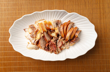 Fresh pork head meat in white porcelain dish on vintage background