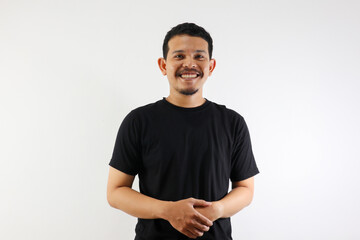 Fototapeta premium a young asian man with black t-shirt smiling at the camera while standing