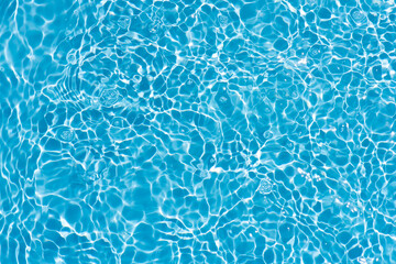 Blue water with ripples on the surface. Defocus blurred transparent blue colored clear calm water...