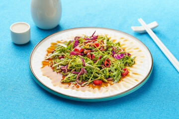 Northeast specialty cold dish small dried fish mixed with bitter chrysanthemum on monochrome...