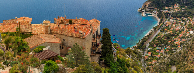 Scenic view of the Mediterranean coastline and medieval houses from the top of the town of Eze village on the French Riviera - obrazy, fototapety, plakaty