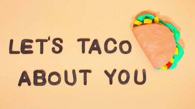 Plasticine stop motion animation. Funny comic phrase lets tako about you on the background of a plasticine taco. Claymotion