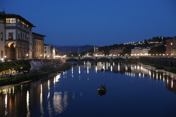 Sunset over the River Arno in the summer. Beautiful Ponte Vecchio city. Night view of the old town country. Dusk over the medieval city. Natural beauty in the evening.
