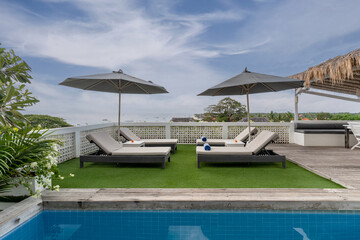 Fototapeta premium Beach sun lounges at hotel pool