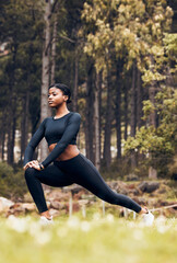 Stretching, fitness and black woman lunge in nature for exercise, training and sports in forest. Hiking, mountain and female person stretch legs for warm up, workout and wellness for performance