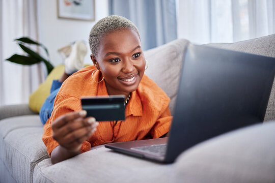 Laptop, relax or black woman online shopping with credit card for digital product with discount code. Smile, promo or happy girl with financial payment to buy on sale on fintech application at home