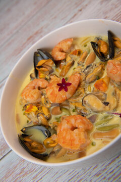 Recipe for marinated mussels with fresh cream, saffron curry and prawns. High quality photo