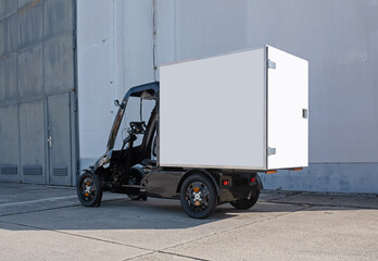 A modern electric delivery 4-wheel Quadracycle bike with a blank white cargo box with copy space...