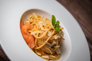 Recipe for homemade spaghetti with tomato sauce, smoked salmon, roasted peanuts and parmesan. High quality photo