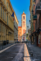 Fototapeta na wymiar Empty streets of the Old Town and the Caserne Rusca clock tower in Vieille Ville of Nice France at sunrise