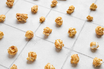 Tasty popcorn on white tile background