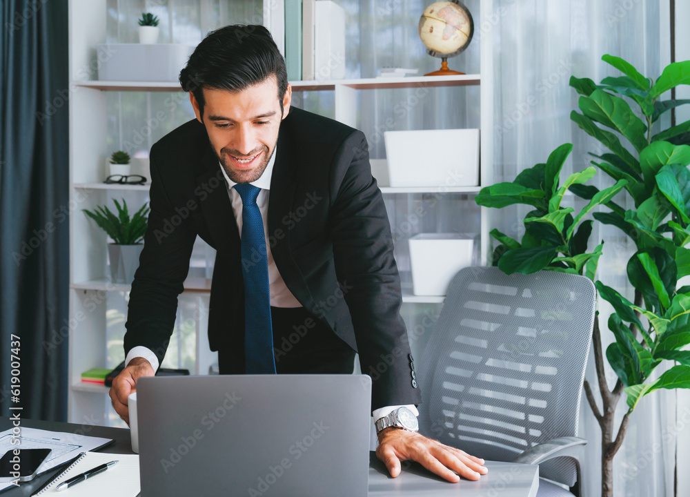 Aufkleber modern professional businessman at modern office desk using laptop to work and write notes. diligent