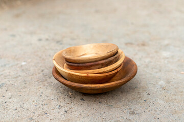 Several different sizes wooden bowls. selective focus with blurred background.