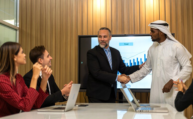 Image two business partner arab meeting successful handshake together with success join congratulation good deal contract in modern office.Partnership approval and teamwork concept