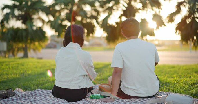 Couple go picnic at the park in the evening