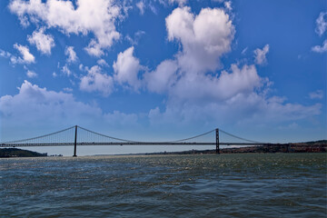 View from a river with a bridge on the horizon