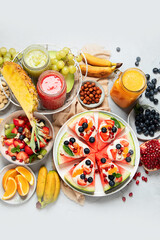 Summer fruits assorted on white background. Fresh raw food concept.