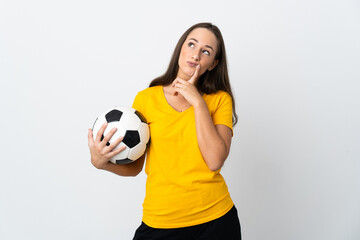 Young football player woman over isolated white background having doubts while looking up