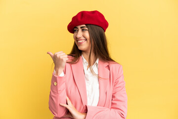 Young caucasian woman isolated on yellow background pointing to the side to present a product