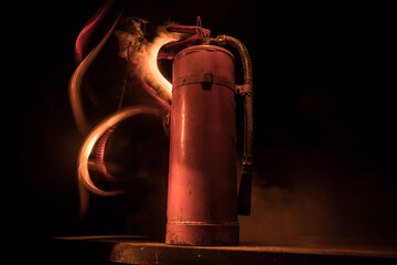 Fire extinguisher on dark background. Fire protection concept.