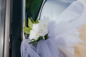 Automobile door adorned with a vibrant and elegant floral bouquet on a wedding