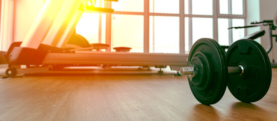 dumbbells in the gym on the floor, the concept of proper nutrition and fitness, a place for the...