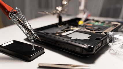 the master solders the chip with a soldering iron