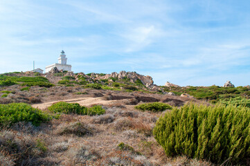 Fototapeta na wymiar Rocky sea coast with a lighthouse in the Capo D'Orso area on the island of Sardinia, Italy