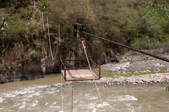 Oroya to transport material or people in a river in the Peruvian jungle. Basket suspended from two rings, which runs along a rope.